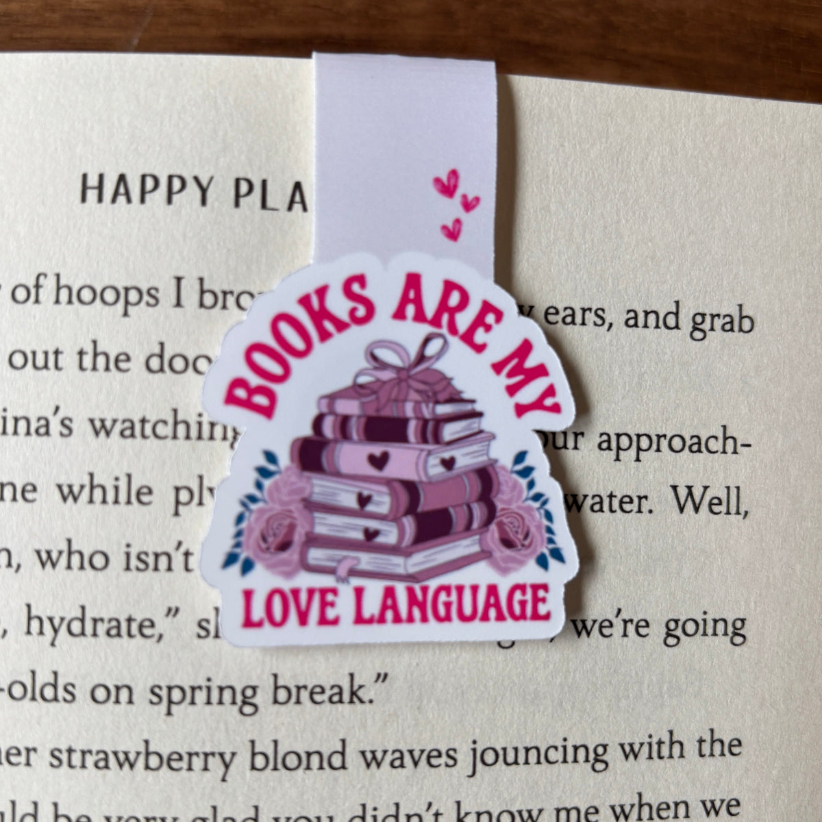 Bookmark with 'Books are my love language' design on a book page