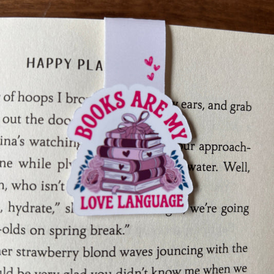Bookmark with 'Books are my love language' design on a book page