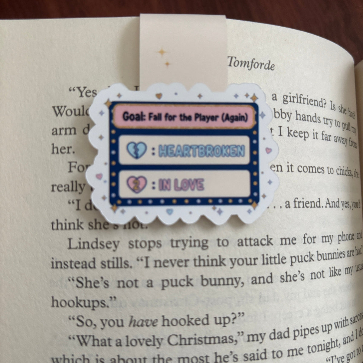 Heart-themed hockey bookmark on an open book with text