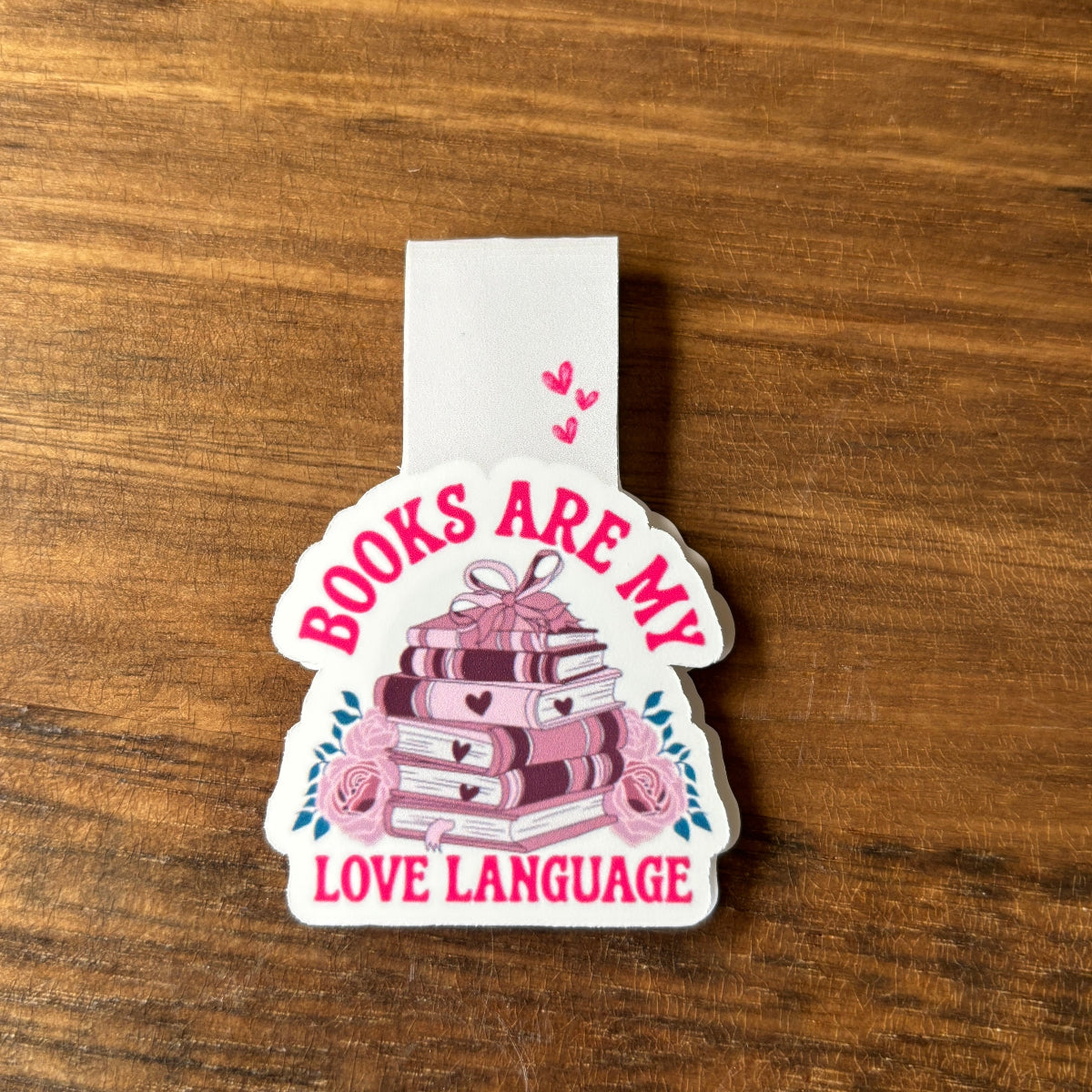 magnetic bookmark with 'Books are my love language' text on a wooden surface