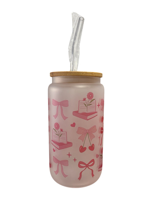 Pink tumbler with bow and book design on a white background