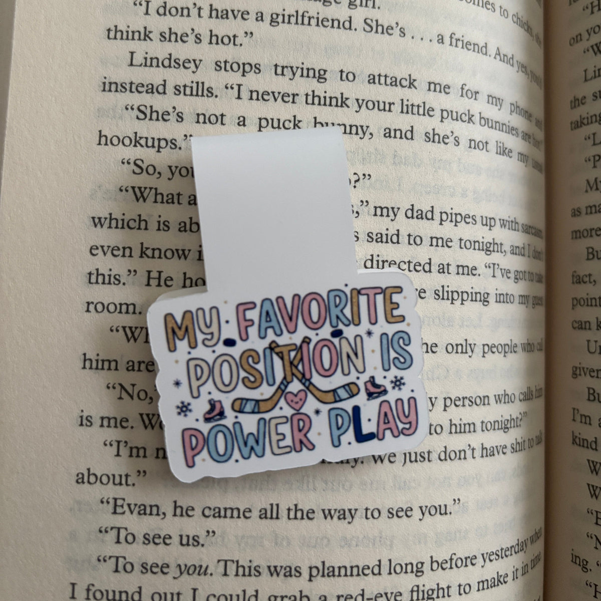 Colorful 'My Favorite Position is Power Play' magnetic bookmark on a book page