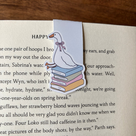 Bookmark with a duck illustration on a book page