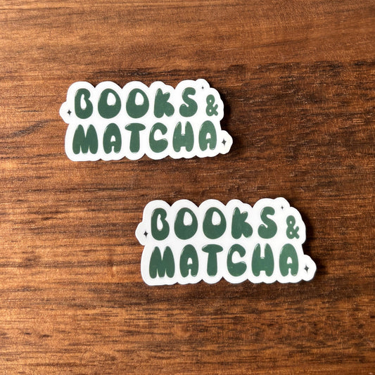 Two 'Books & Matcha' stickers on a wooden surface